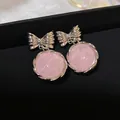 Detailed macro view of sweet pink marble drop earrings with silver bowknot studs - Silver Needle / Pink
