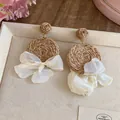 Detail of Bohemian raffia woven earrings with elegant cream chiffon bow accents - Raffia Chiffon Flower Style / Coffee and Yellow