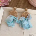 Detailed view of bohemian raffia woven earrings with light blue chiffon ribbons - Raffia Chiffon Flower Style / Brown With Blue