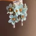 Close-up of light blue fabric flower earrings with elegant teardrop pearl tassels - Tassel Flower Stud Earrings (65#) / Light Blue (65#)