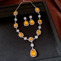 Detailed view of a luxury orange teardrop crystal necklace and earring jewelry set - Necklace and Earrings Set / Silver Brown