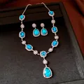 Elegant silver necklace and earrings set featuring light blue teardrop rhinestones - Necklace and Earrings Set / Silver Blue