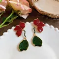 Détail des boucles d'oreilles fleurs 3D en émail avec pétales rouges et base verte. - Style Fleur Plissée 3D (HE33298) / Rouge Vert Or