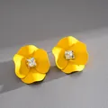 Detail view of yellow spray-painted flower stud earrings with square crystal centers - Yellow