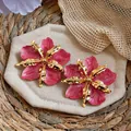 Detail of pink marble-textured oil-dripping flower earrings with golden metallic petals - Gold-Rose Red