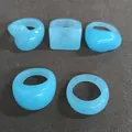 Set of five trendy light blue candy-colored resin rings in various shapes. - 5 Pieces / Blue