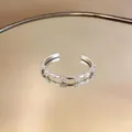 Elegant silver open ring with delicate daisy floral patterns in a detailed macro view - Daisy Style (1#) / Silver