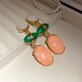 Close-up detail of vintage resin oval teardrop earrings displayed in a velvet jewelry box - Silver Earring Post Style / Beige-Green-Orange