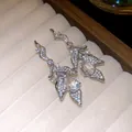 Detailed view of silver-plated leaf earrings featuring sparkling teardrop zircon pendants - Clear / Pair / Silver