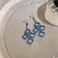 Detailed view of elegant blue zircon flower tassel earrings with vintage French charm - Silver-Blue