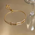 Detailed close-up of a vintage gold bamboo-shaped bracelet with sparkling zirconia stones - Rhinestone Bamboo Style