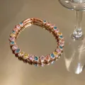 Detailed view of rose gold bracelet featuring vibrant multicolored pear-shaped cubic zirconia - Colorful Teardrop Style