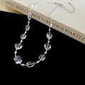 Detailed macro close-up of clear faceted crystal beads and white bead choker necklace - White
