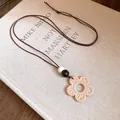 Close-up of resin flower pendant with wax cord and wooden beads necklace - Flower Pendant / Brown