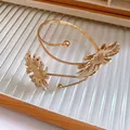 Close-up of golden pleated flower armlet bangle with intricate sunflower petal details - Sunflower Style Arm Cuff