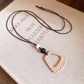 Detailed macro shot of a boho resin geometric pendant necklace with wax cord and beads - Rectangular Pendant / Brown