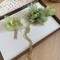 Detailed view of green fabric flowers with elegant gold beaded tassels on Hanfu hair clips - Gold Green Lily Of The Valley Style / One Pair / Gold Green
