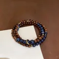 Detail of retro ethnic style bracelet with dark wood and blue stone beads - Blue-Brown