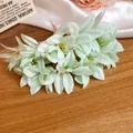 Close-up of mint green fabric flower hairpin with realistic dewdrop details on petals. - Green