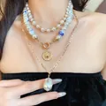 Close-up of vintage multi-layer necklace with ceramic beads and baroque pearl pendant - Necklace Set (3-Piece Set) / Gold-White
