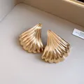 Primo piano di eleganti orecchini a lobo dorati a ventaglio con finitura vintage - Stile Plissettato a Ventaglio / Ago d'argento / Oro