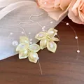 Close-up of elegant petal earrings featuring shimmering zircon and pearl tassel details - Earring Hooks / Yellow