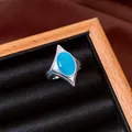 Detail of a vintage geometric silver ring with a vibrant blue cat's eye stone - Silver-Blue