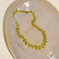 Close-up of 14k gold plated necklace with olive green faceted beads and pearl detail. - Gold-Green