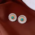 Detailed macro shot of vintage silver turquoise stud earrings with sparkling zircon accents - Silver Gold Blue