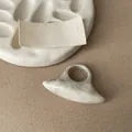 Detailed macro view of a unique marble patterned resin ring with chunky oval shape - White