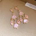 Gros plan de boucles d'oreilles vintage en acétate rose avec détails en zircon - Rose