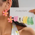 Close-up detail of dopamine colored resin flower and hoop earrings set on a display card - Silver Earring Post - Colorful / 10-Piece Set