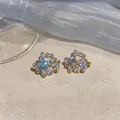 Elegant gold-tone zircon ear clips featuring a sparkling floral cluster design for women - Gold