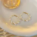 Detailaufnahme vergoldeter Creolen mit eleganten und klaren Glasperlen im Detail - Gedrehter Runder Weißer Stil (Style 7)