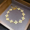Detailed close-up of a French style flower bracelet with cat's eye stones in gold finish - Floral (HB6023) / Gold