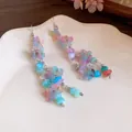 Close-up detail of dopamine colorful resin flower tassel earrings on a white plate - Earring Hooks / Colorful