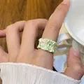Macro view showing detail of fresh green drip oil flower ring with wavy gold edges - Butterfly Floral Style (HR3113-1) / Green