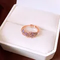 Macro view of an elegant rose gold ring with purple and clear zircon cluster design - Open (HR3542) / Purple