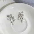 Elegant star pearl dangle earrings with sparkling zircon on a white ceramic plate - Silver Earring Post Style / Silver