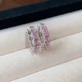 Detail view of dainty silver hoop earrings featuring brilliant pink round-cut cubic zircons - Round Hoop / Silver-Pink