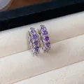 Elegant silver-toned hoop earrings set with sparkling purple round-cut zirconia stones. - Round Hoop / Silver-Purple