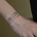 Close-up of minimalist metal mesh and thin chain bracelets on a wrist - Silver Stacked Bracelet (HB5824-) / Silver