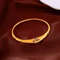 Detail of elegant gold-plated bangle featuring marquise-cut zircon gemstone inlay. - Bangle / Gold
