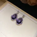 Detailed macro view of elegant pear-shaped purple zircon earrings with sparkling halo - Drop Earrings (HR3508) / Silver Needle / Purple