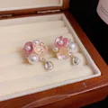 Close-up detail of sweet floral earrings with pearls and crystal drops presented in a wooden box - Silver Post Stud (50)