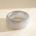 Close-up of a chunky iridescent resin bangle featuring holographic star glitter and sequins - Iridescent Gray (Silver Glitter)