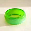 Detailed macro view of the vibrant green resin bangle with sparkling iridescent texture - Iridescent Green