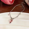 Close-up of a pink resin strawberry necklace with bead accents on a dainty silver chain. - Silver-Pink