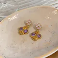Close-up of gold-plated flower stud earrings with purple and yellow zircons. - Multicolor Floral Drop / 925 Silver Needle / Gold