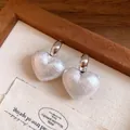 Close-up detail of vintage heart-shaped textured pearl earrings with silver posts - Heart Pendant (Silver) / Pearl White
